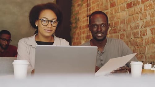 Afro-American Man and Woman Posing for Camera on Business Lunch in Cafe