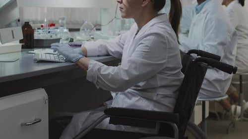 Scientist Working in Lab With Computer and Mouse