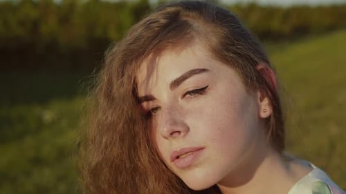 Lady with Long Hair Looking at Camera on Summer Nature Among Bush Plantation