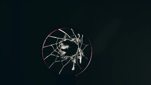 Basketball Swishes Through Net in Dramatic Lighting