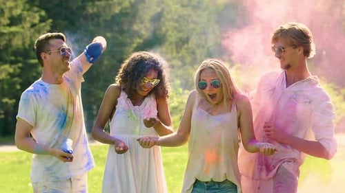 Funny Young Men Throwing Colorful Powder Over Women's Heads, Holi Festival