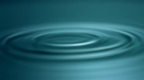 Water Droplets Creating Ripples on Teal Surface