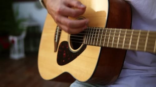 Close Up of Man's Hands Playing Acoustic Guitar