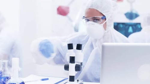 Chemical Scientist Using Modern Microscope in Research Laboratory