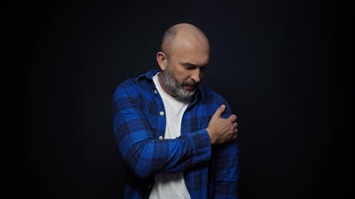 Man Massaging Aching Shoulder and Neck