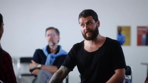 Man Speaking to Group in Meeting