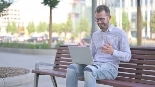 Man Working on Laptop Celebrates Good News