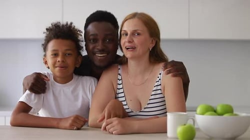 Happy Family Smiling Together in Modern Kitchen