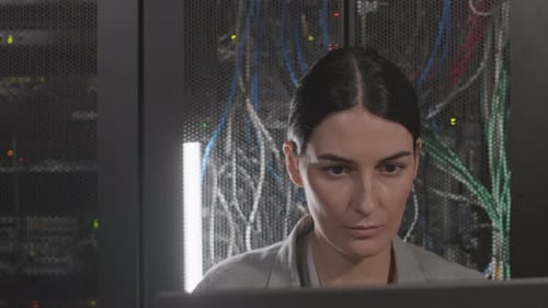 Woman Works with Servers in Data Center