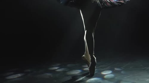 Ballerina's Legs Dancing in Pointe Shoes on Stage