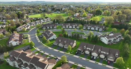 Residential town houses in USA during spring season. Green nature. Golden hour light. Aerial view of