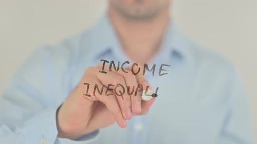 Man Writes Income Inequality on Glass
