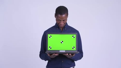 Young Adult Holding Laptop with Green Screen