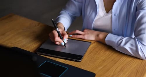 Illustrator hands scetching on tablet computer, using stylus