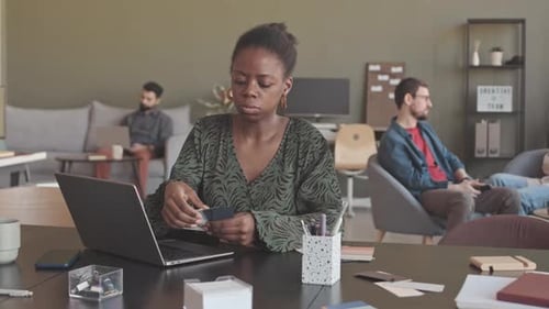 Female Designer Choosing Product Color from Palette in Office