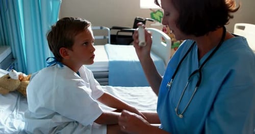 Female doctor helping patient use inhaler