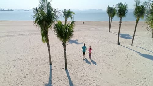 Drone view of woman running with the best friend. Shot with RED helium camera in 8K