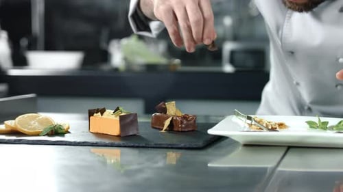 Chef Garnishing Elegant Desserts with Chocolate and Mint