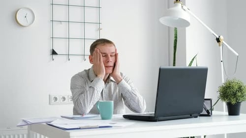Stressed Businessman Trying to Work in the Office