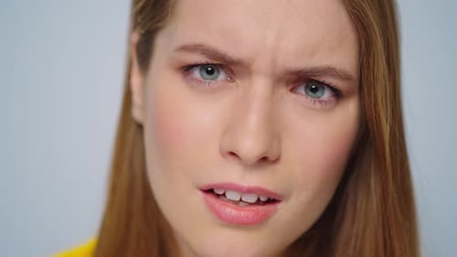 Closeup Angry Woman Waving Head on Camera in Studio