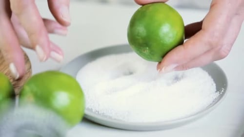 Zesteing fresh lime for key lime margarita.