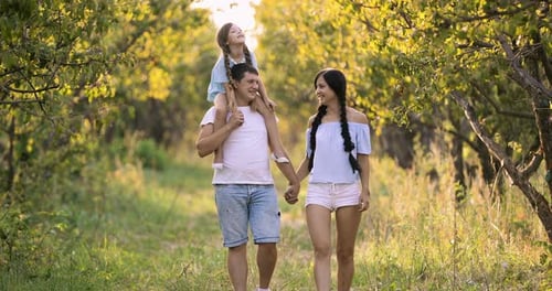 Family Walks in the Garden Young Girl on Fathers Shoulders