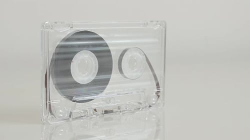 Close-up of transparent analogue magnetic tape 4K 2160p 30fps UltraHD footage - Tilting on compact