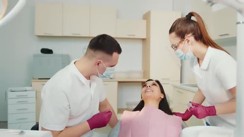 The Dentist Together with the Assistant Examine the Patient in the Dental Clinic