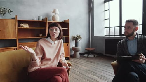 Couple in Tense Therapy Session in Modern Office