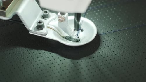 Closeup of sewing machine working part with leather. Cnc sewing machine