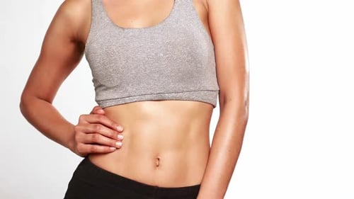 Athletic Woman Checks Her Flat Stomach