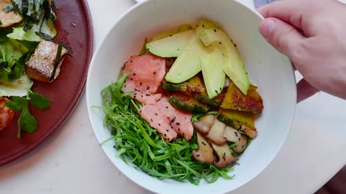 Salmon Salad with Avocado Zucchini Top View Hand Rotating