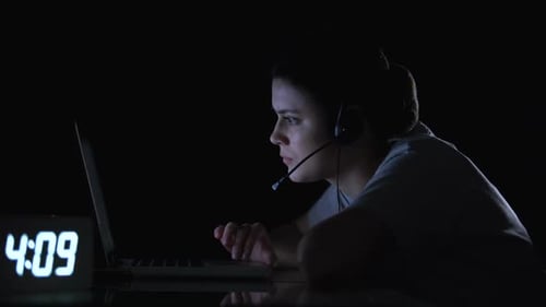 Woman Works Late at Night on Laptop