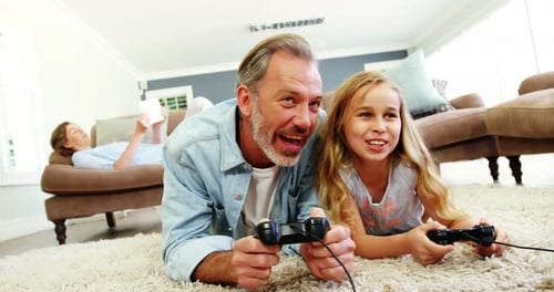 Grandfather and Granddaughter Play Video Games at Home