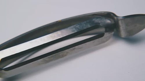 Close Up of Vegetable Peeler with Green Handle