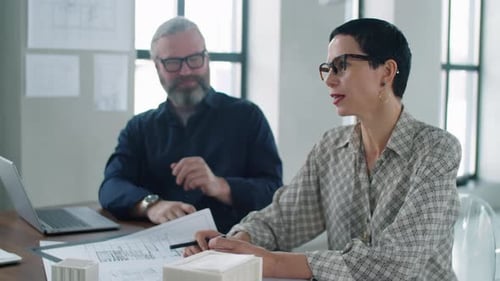 Architects Collaborate on Project in Modern Office