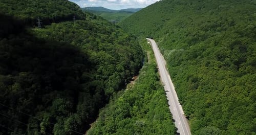Aerial View of a Rural Highway Between Mountains