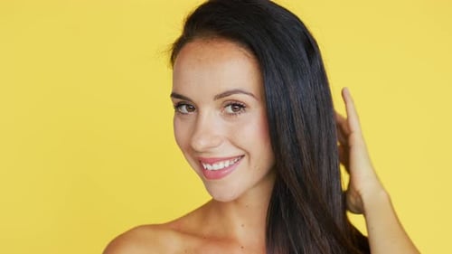 Smiling Woman Posing with Smooth Hair in Studio