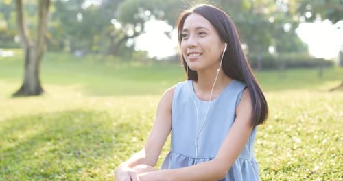 Woman listen to music at park