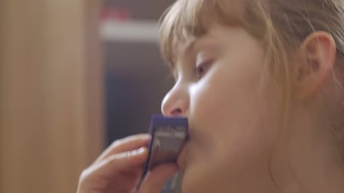 Child Playing Harmonica Close Up