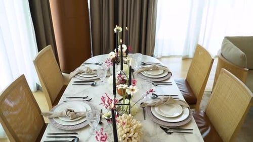 Beautiful Table Setting with Black Candles and Flowers