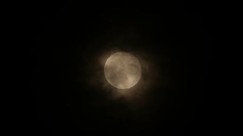 Glowing Moon with Passing Clouds at Night