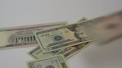 Dollars Falling onto a White Surface