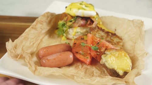 Delicious Breakfast with Poached Egg Potatoes and Sausage on a White Plate