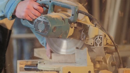 Carpenter cutting wood in the workshop