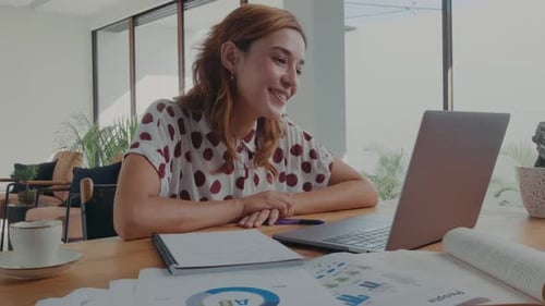 Smiling Woman Using Laptop for Video Conference