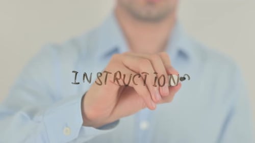 Hand Writes Instructions on Clear Surface With Marker