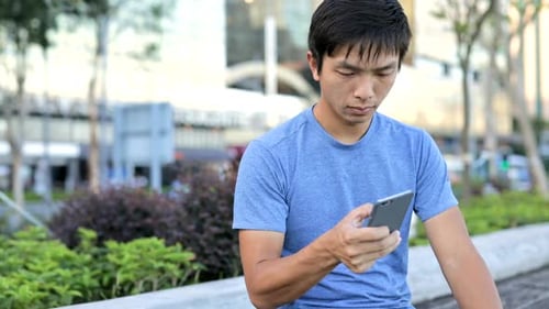 Man using cellphone in city