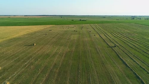 Aerial View Hay Bales at Agricultural Field in Summer at Sunset Haystack