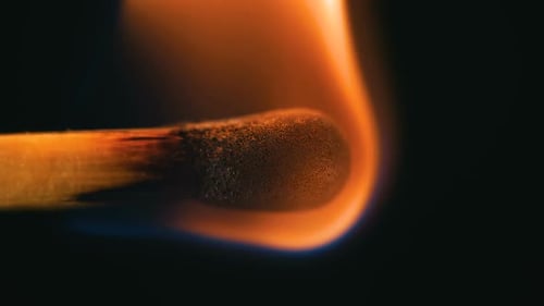 Match Igniting in Dark Extreme Close Up